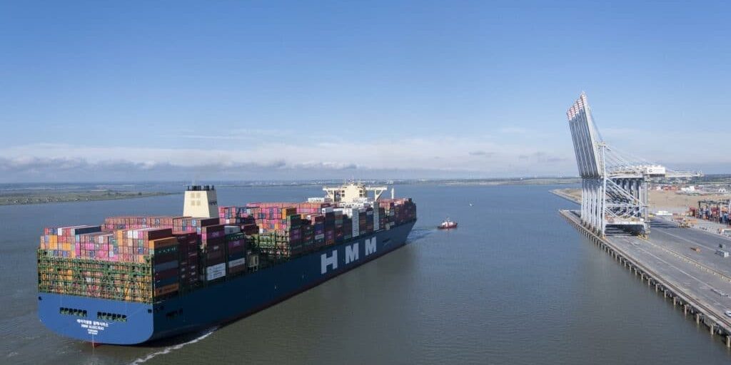 Photograph of a freight ship with lots of containers in the Thames Estuary